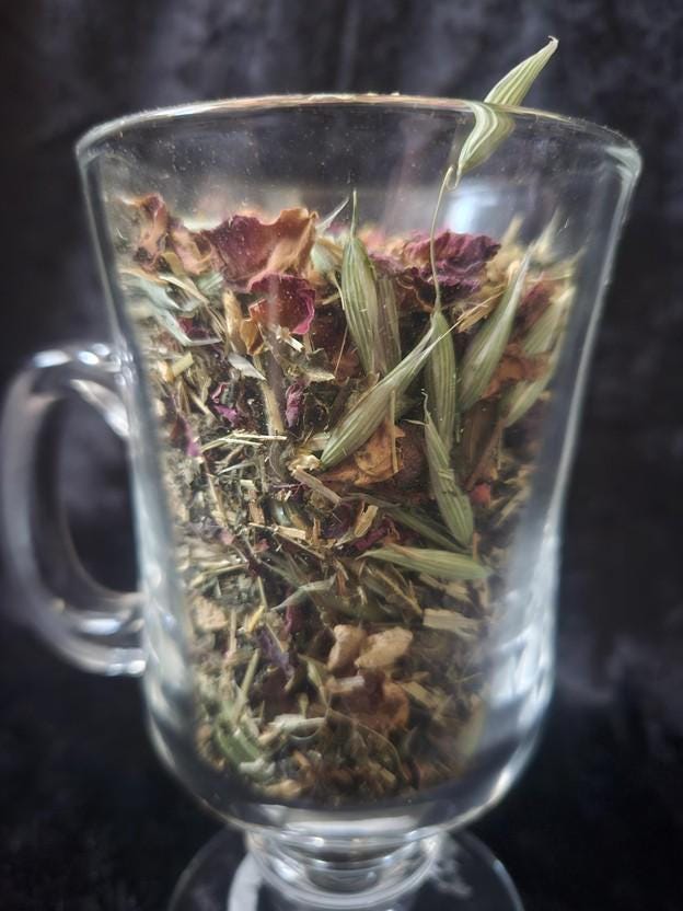 Close up of mineral-rich loose leaf herbal tea with nettle leaf, oatstraw, rose petals and hawthorn berry.