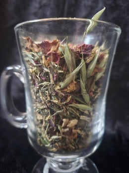 Close up of mineral-rich loose leaf herbal tea with nettle leaf, oatstraw, rose petals and hawthorn berry.